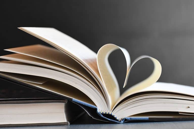 Book with pages rolled up on a heart shape symbolising A message from the heart