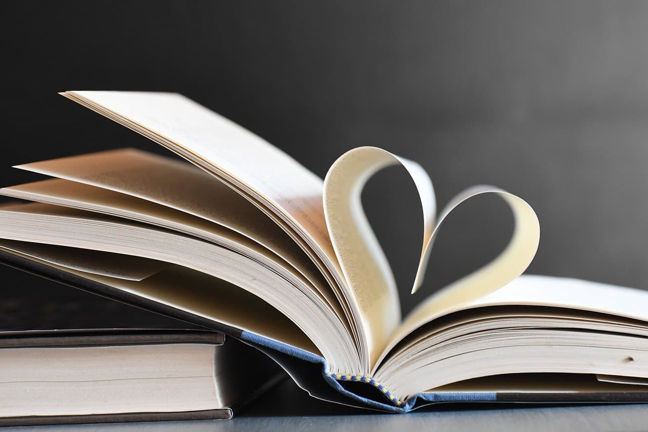 Book with pages rolled up on a heart shape symbolising A message from the heart
